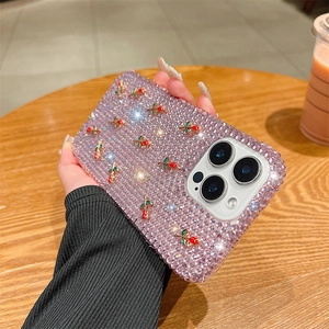 Detail of pink rhinestone iPhone case featuring 3D red metal roses and luxury craftsmanship