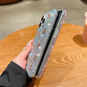 Detailed view of luxury iPhone case with full rhinestones and 3D lipstick charms