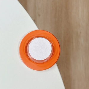 Orange and white circular desk corner protector safety cushion shown installed on table