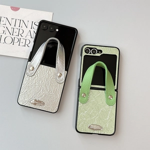 Textured leather flip case for Samsung Galaxy Z Flip 6 with stylish hand strap and metal logo