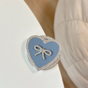 Detail of blue leather heart phone grip with sparkling rhinestones and a bow accent