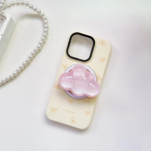 Detail of pink glitter cloud phone grip on beige case with yellow bow and pearl decor