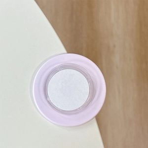 Close-up of a pink round magnetic collapsible phone grip showing soft silicone details