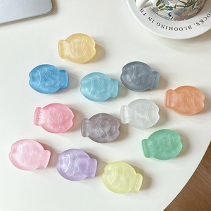 Matte macaron-colored taiyaki fish phone grips in various pastel colors on a desk