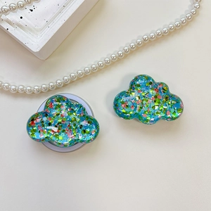 Detailed view of cloud-shaped phone socket with vibrant glitter and resin texture