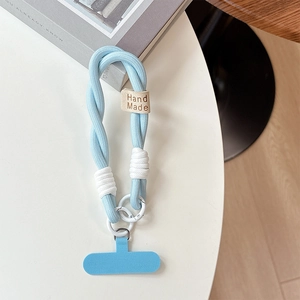 Close-up of light blue braided cotton phone wrist strap with leather Hand Made tag