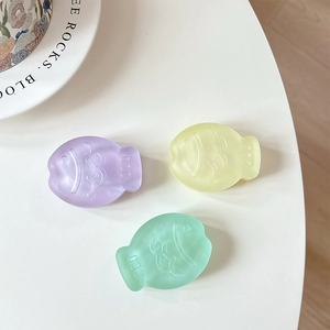 Matte fish-shaped expandable phone socket grip in pastel purple yellow and green