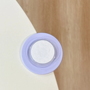 Close-up of a lavender magnetic foldable phone socket on a minimalist white surface