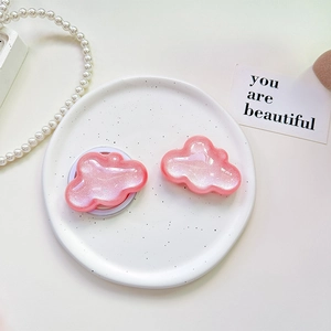 Glittery pink cloud phone grip on porcelain tray with elegant pearl accessories