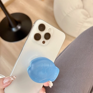 Blue matte cartoon fish phone grip holder attached to white smartphone for hand support