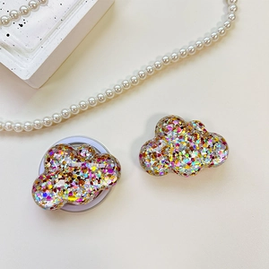 Macro shot of cloud-shaped phone socket with glitter sequins and foldable white base