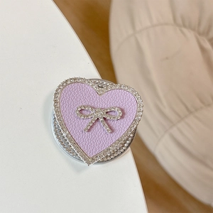 Close-up of heart-shaped grip tok with lavender leather texture and rhinestone bowtie