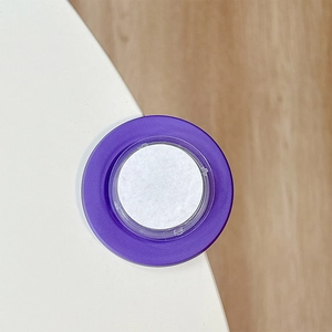 Detail view of purple magnetic pop socket phone holder base with adhesive attachment