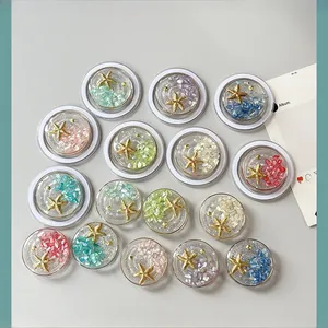 Detail view of round resin phone grips featuring golden starfish and colorful stones inlay