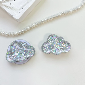 Macro shot of silver cloud phone socket with holographic sequins on a white background