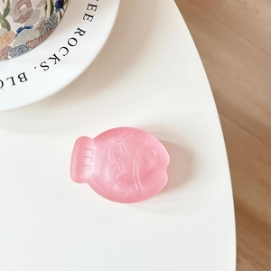 Close-up of pink matte Taiyaki fish phone socket with 3D embossed facial features