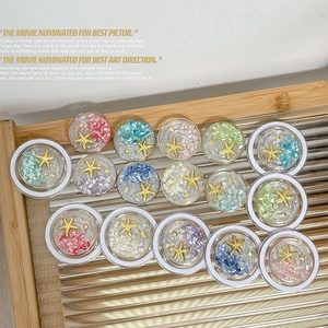 Detailed grid of colorful shell and starfish phone grip accessories on wood tray