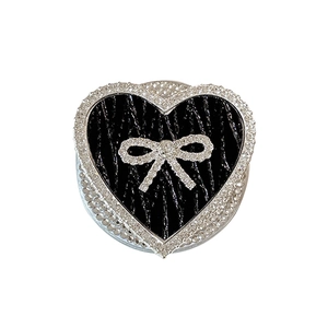 Luxe heart-shaped phone grip with black leather texture and sparkling rhinestone bow detail