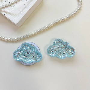 Detail of light blue glitter cloud phone grip showing both front and back adhesive side