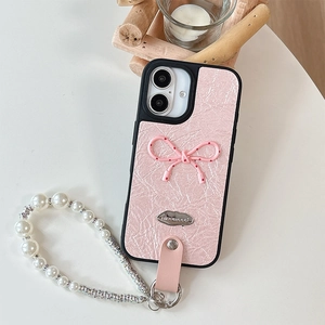 Detail of pink leather case with polka dot bow and white pearl beaded wrist strap