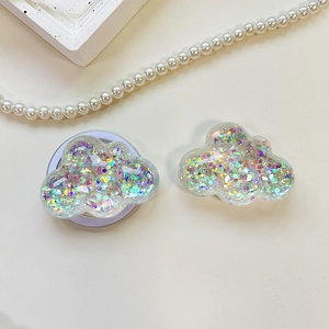Detail of cloud-shaped phone socket with iridescent sequins and retractable base