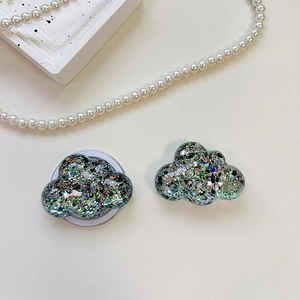 Detailed view of cloud-shaped phone socket with iridescent glitter and resin finish