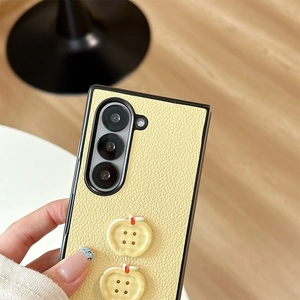 Detail of light yellow leather phone case with 3D apple buttons for Samsung Z Fold