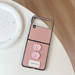 Detailed view of pink lychee leather phone case with apple-shaped plaid buttons and stitching