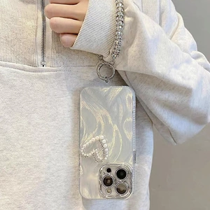 Pearlescent heart iPhone case with luxury crystal wrist strap and wavy pattern