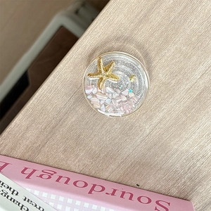 Detailed view of ocean themed phone grip with resin starfish and colorful stones