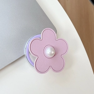 Detailed view of pink leather flower phone grip with pearl accent and fine stitching