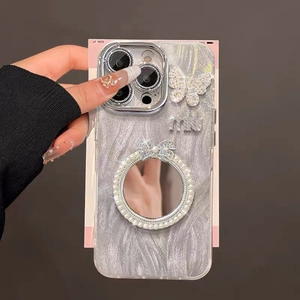 Detailed shot of iPhone case with mirror, butterfly crystals, and pearl chain handle