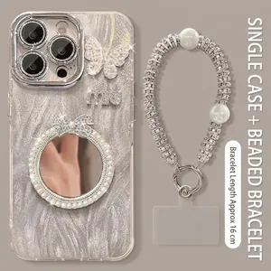 Detailed view of butterfly mirror phone case with pearl chain and beaded bracelet strap