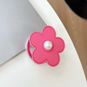 Detail of pink leather flower phone grip featuring a centered white pearl and stitching
