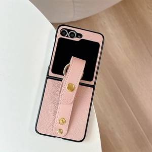 Pink lychee leather case for Samsung Z Flip with wrist strap and gold hardware accents