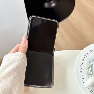 Detail view of foldable smartphone case with black bumper and clear back in half-folded state