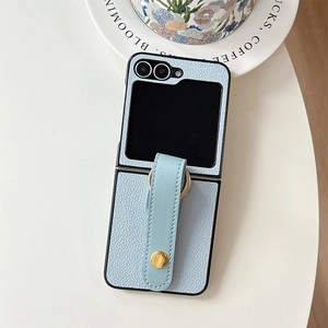 Detail of light blue litchi leather folding phone case with wrist strap and metal ring