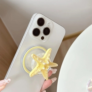 Detail shot of bright yellow 3D starfish phone grip with realistic textured finish