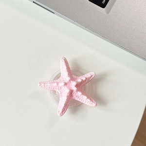 Detail of pink starfish phone grip showing 3D textured surface and transparent base