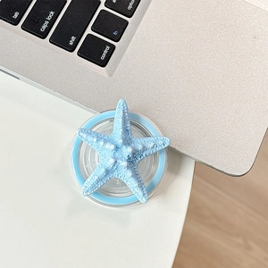 Macro detail of a 3D blue starfish phone socket with realistic textured surface on a desk