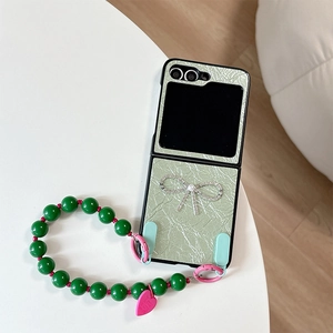 Dettaglio custodia in pelle verde per Samsung Z Flip con fiocco di diamanti e perline