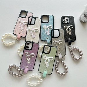 Faux leather iPhone cases with 3D bows and pearl wrist straps in seven pastel colors
