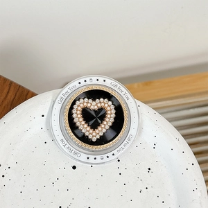 Detail of magnetic phone grip with pearl heart design and Gift For You engraving