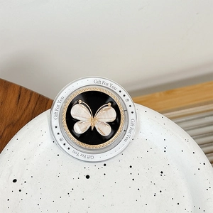 Detail of magnetic flower phone grip with pearl butterfly motif and sparkling crystals