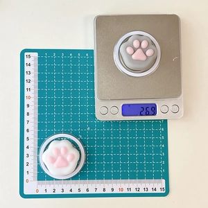 Detailed view of 4cm x 4cm cute cat paw phone grip weight measurement on digital scale
