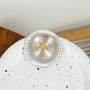 Macro view of magnetic phone socket with golden starfish inlay and Gift For You text