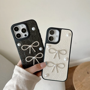 Detail of luxury leather iPhone cases with elegant pearl and rhinestone bow decorations