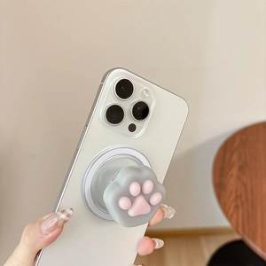 Detailed view of a 3D pink silicone cat paw collapsible grip stand on a white iPhone