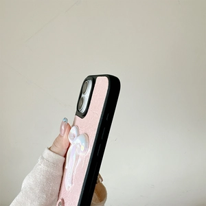 Detail of pink leather phone case with 3D pearl bow and black protective frame