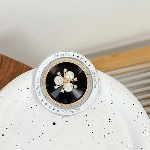 Detail of magnetic flower bowknot phone grip with pearls and 'Gift For You' text